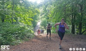 Surrey Fitness Centres members running outdoors through woodland